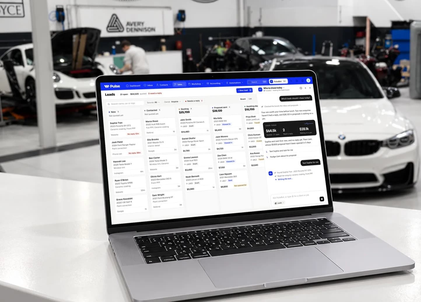 Pulse open on a laptop in a car detailing workshop